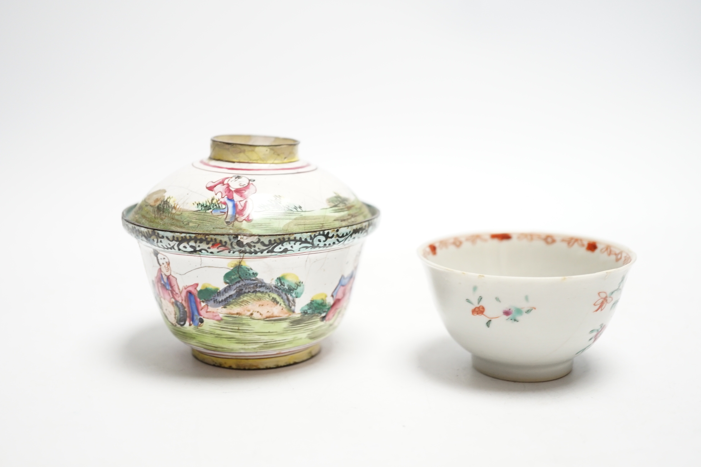 A Chinese Canton enamel tea bowl and cover, and a porcelain tea bowl, largest 8cm high